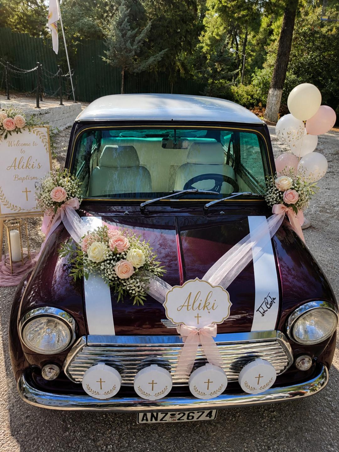 A burgundy classic Mini decorated for a baptism