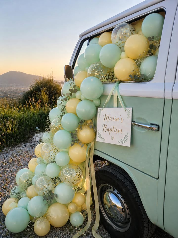 The mint Curists van decorated in soft green and yellow balloons for a baptism